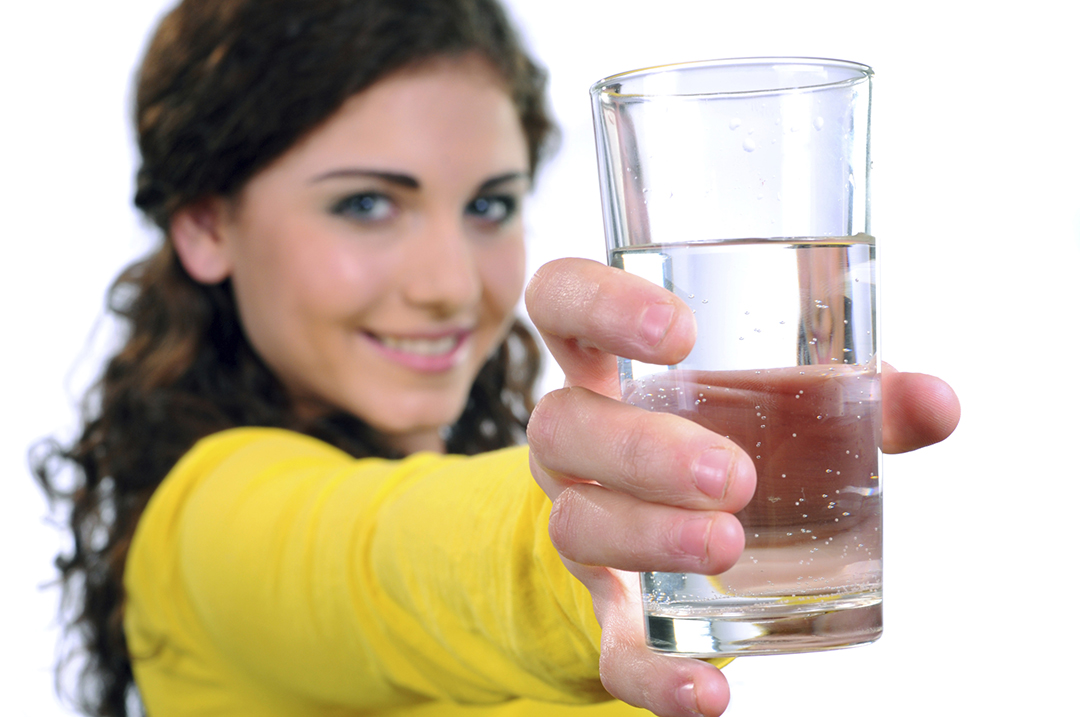 Young Woman Holding Glass of Water