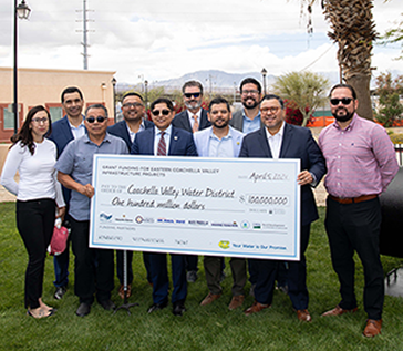 Grant Funding Celebration on April 5 in Mecca, Group Photo with large check